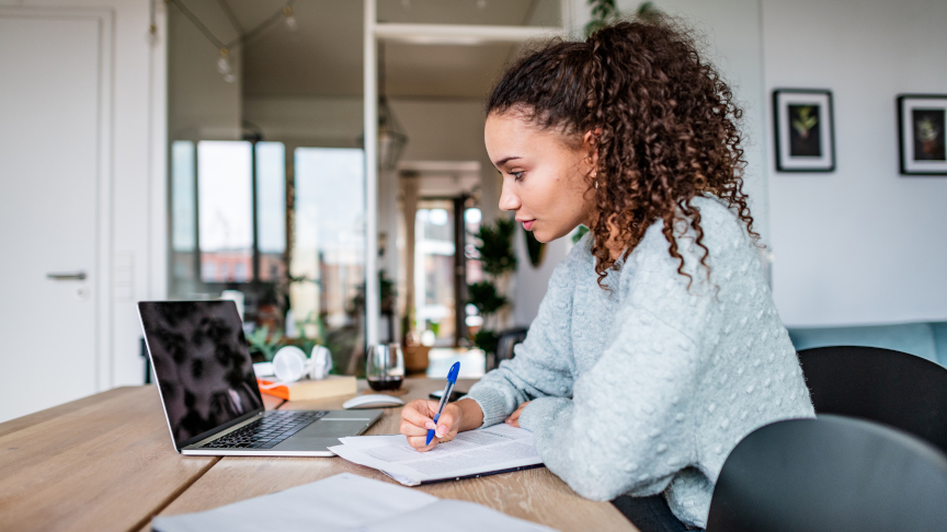 Student sits at home at her laptop and study.